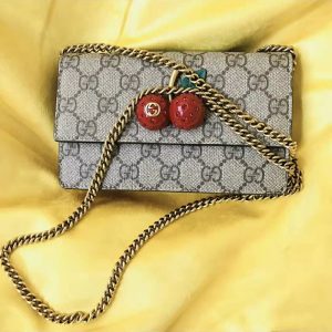 Gucci cherry crossbody bag at the counter