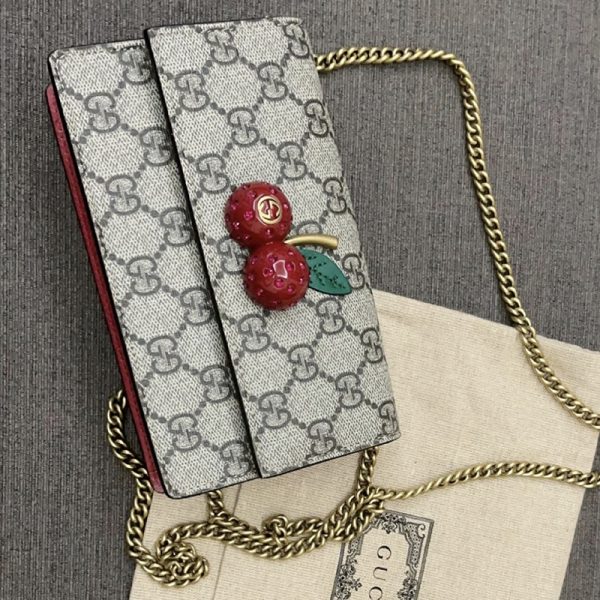 Gucci cherry crossbody bag at the counter - Image 2