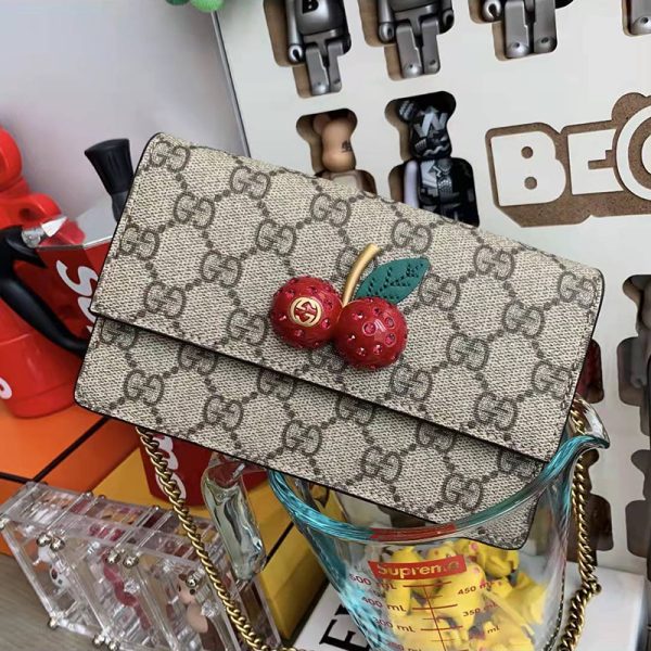 Gucci cherry crossbody bag at the counter - Image 3