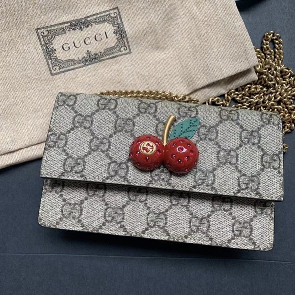 Gucci cherry crossbody bag at the counter - Image 4